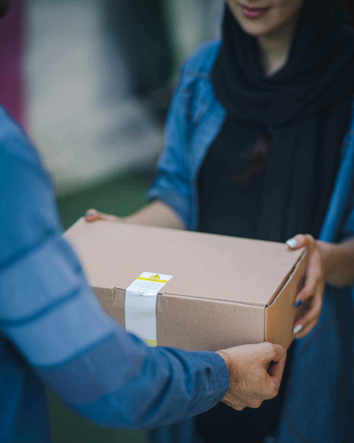 Person handing over a box