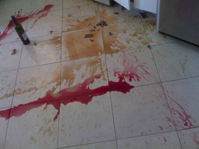 Wine and coffee mug broken and spilled on the floor.