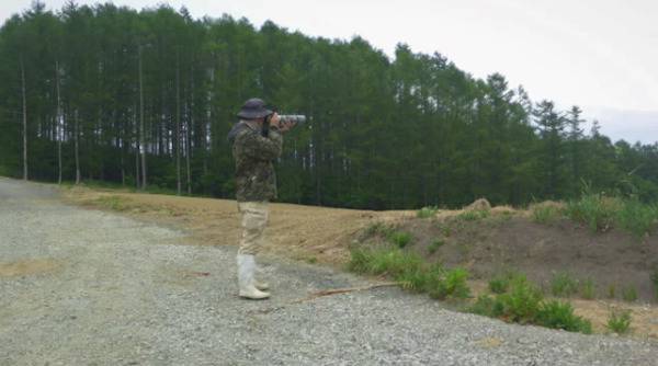 Photographer blending into the wilderness behind them.