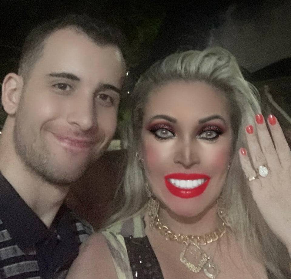 Woman and man posing for an engagement picture. Woman has been heavily Photoshopped