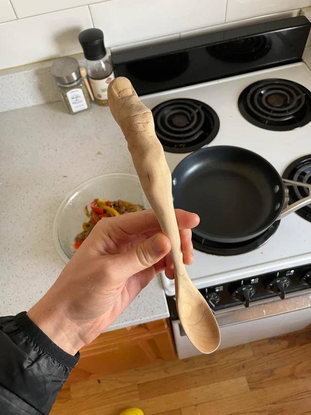 Wooden spoon carved with thumb handle 