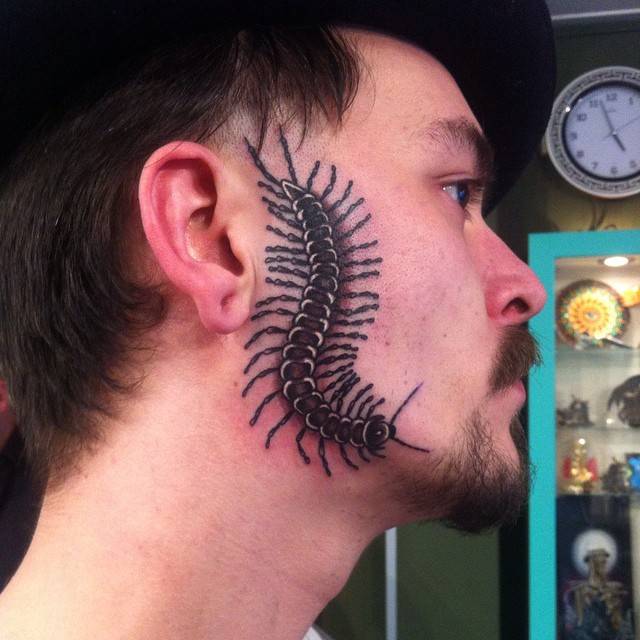Man with centipede tattoo on his face 
