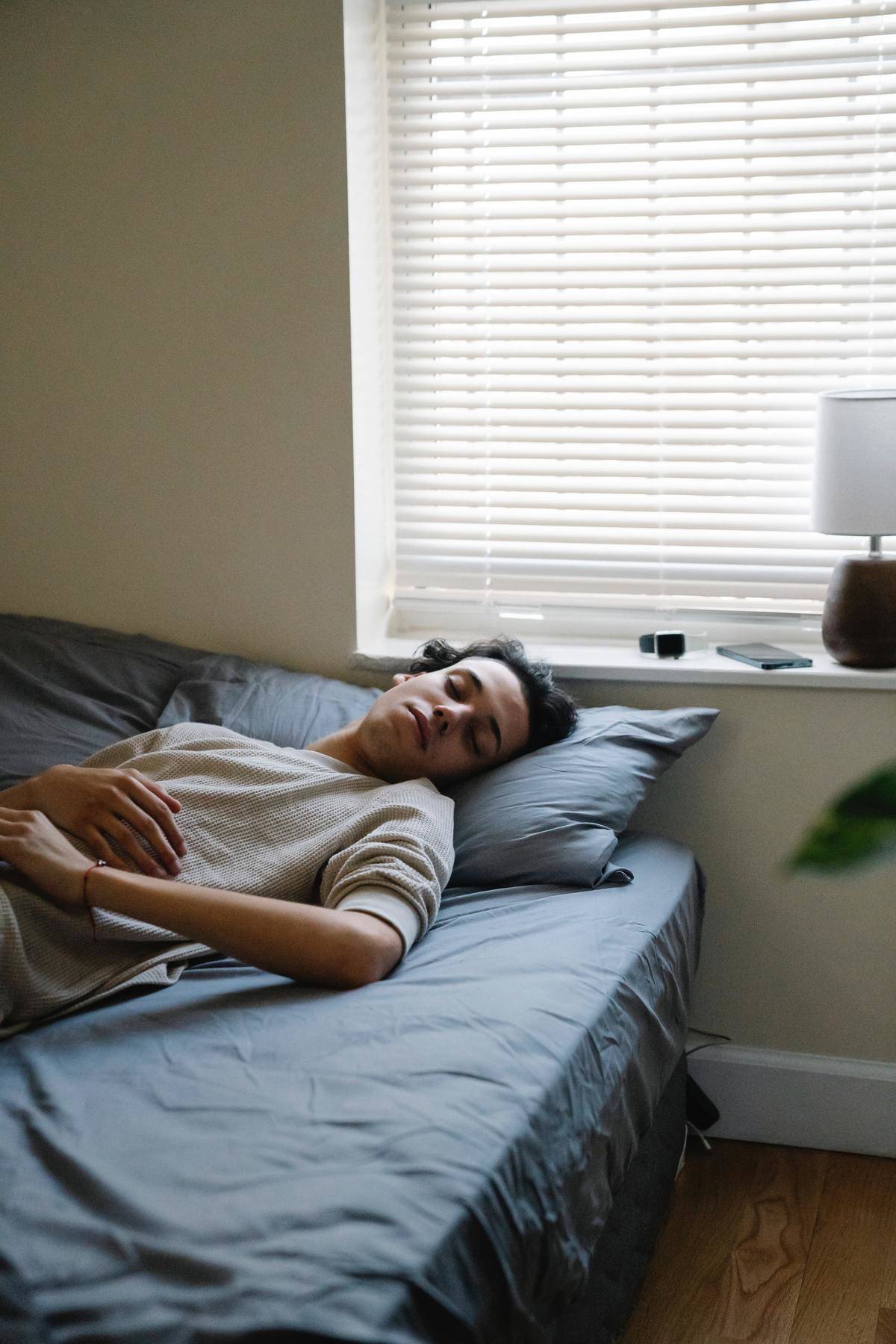 Teenager lying in bed asleep