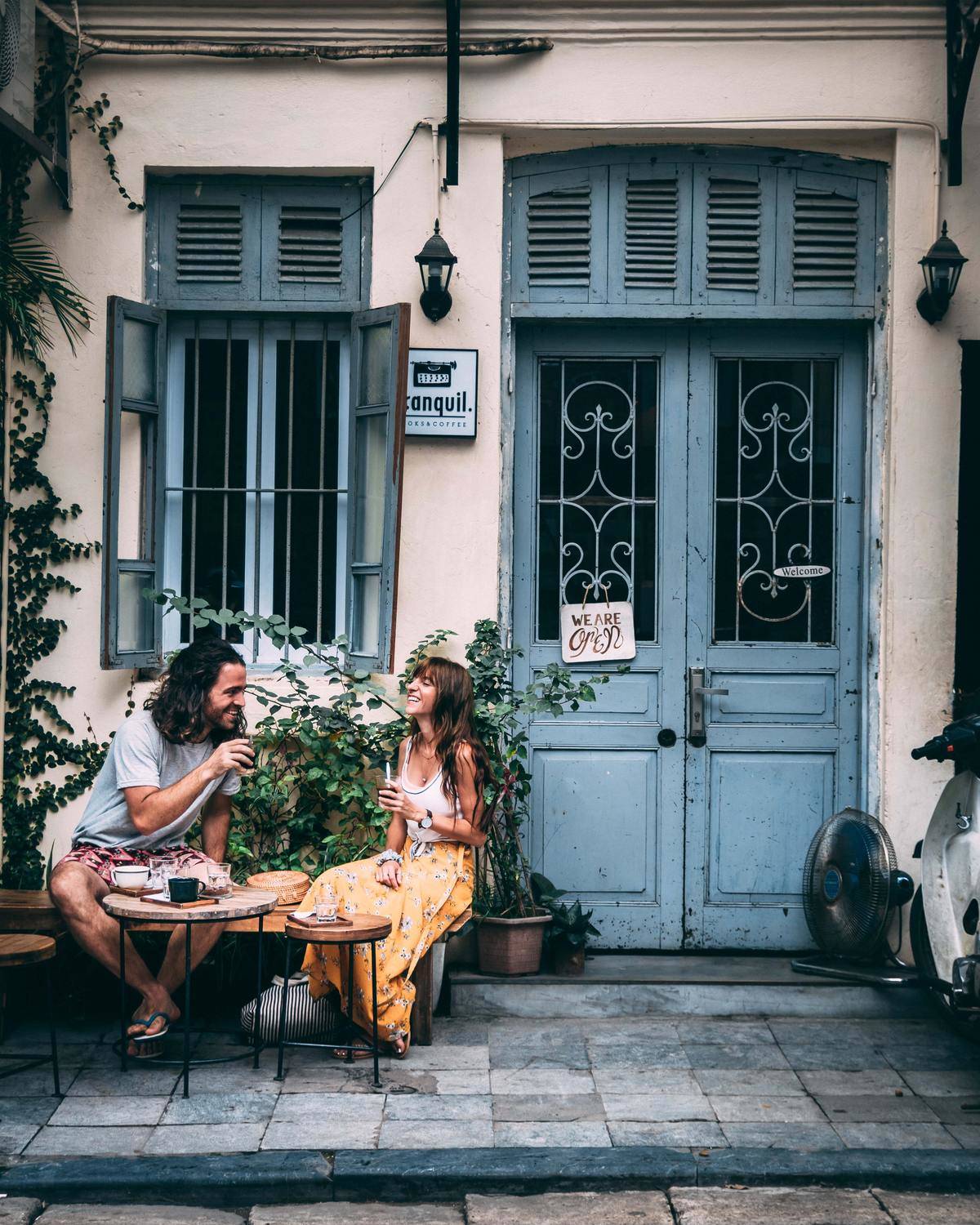 Couple chatting at coffee tables