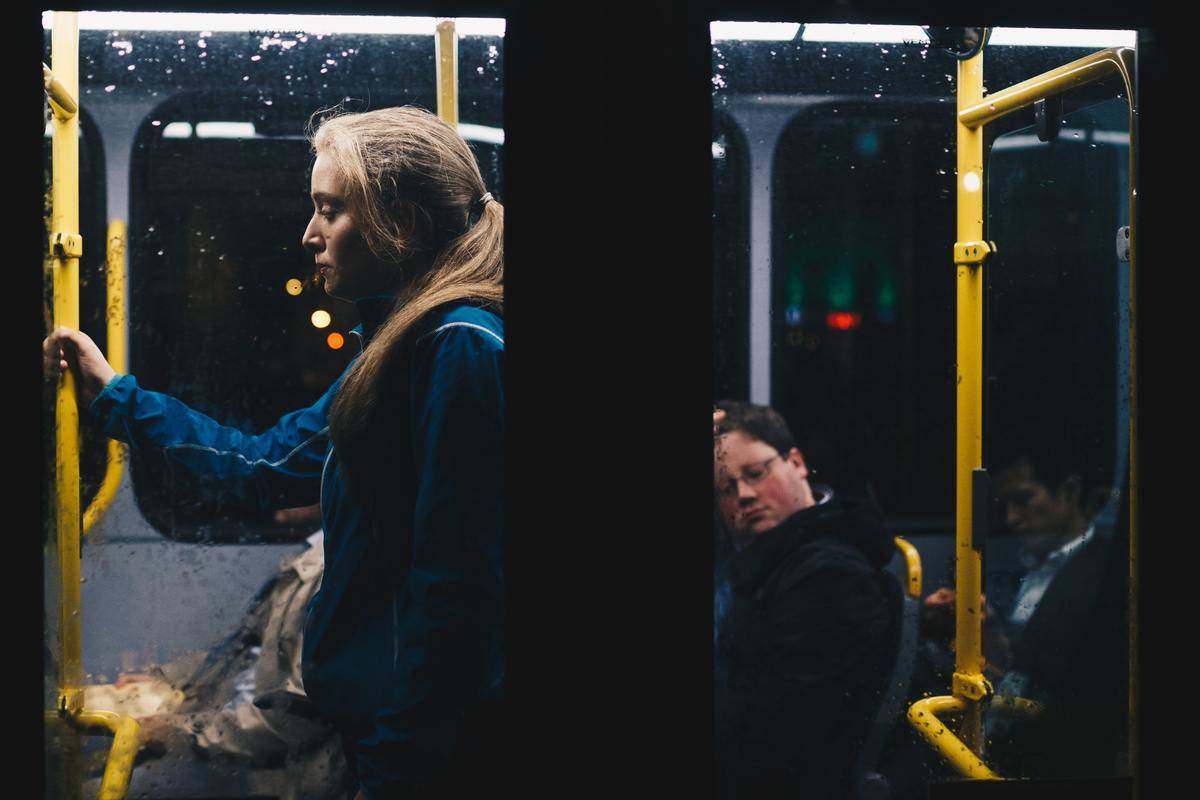 Woman riding city bus alone at night 