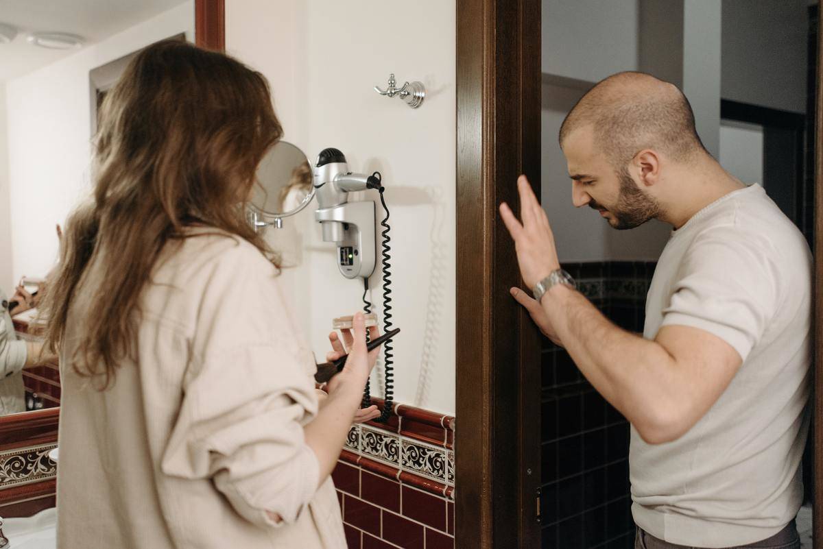 Couple in disagreement in bathroom