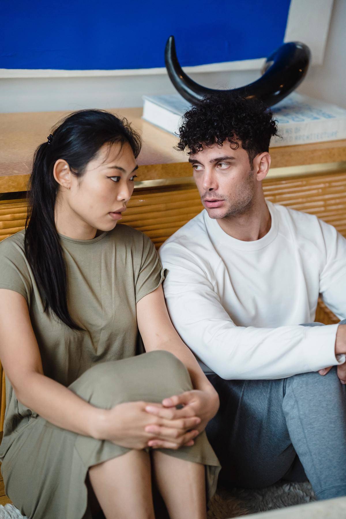 Man and woman looking at each other irritated