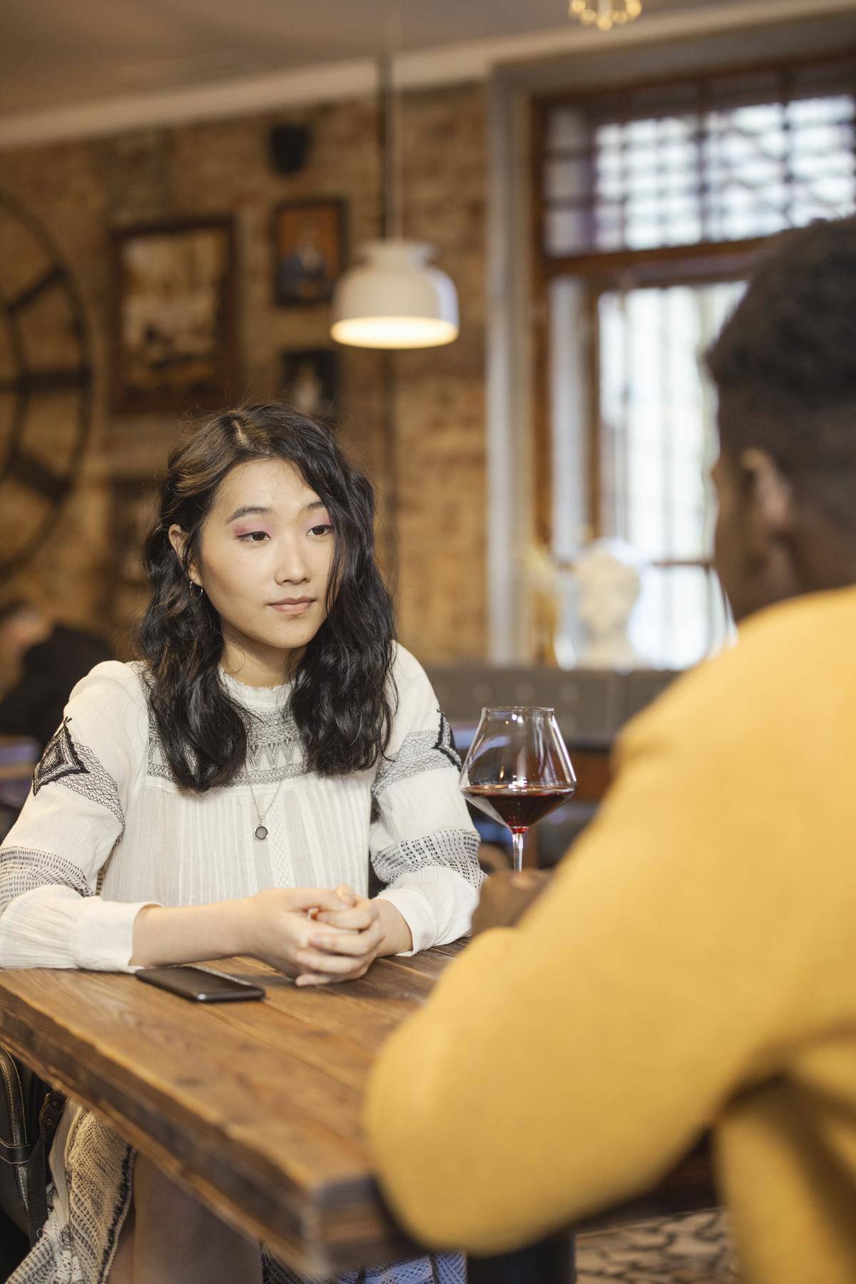 Couple on date, woman listening
