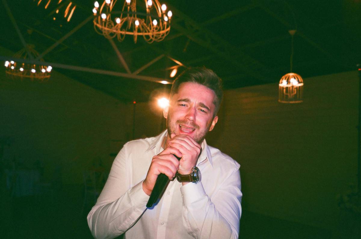 Man yelling into microphone in dark room