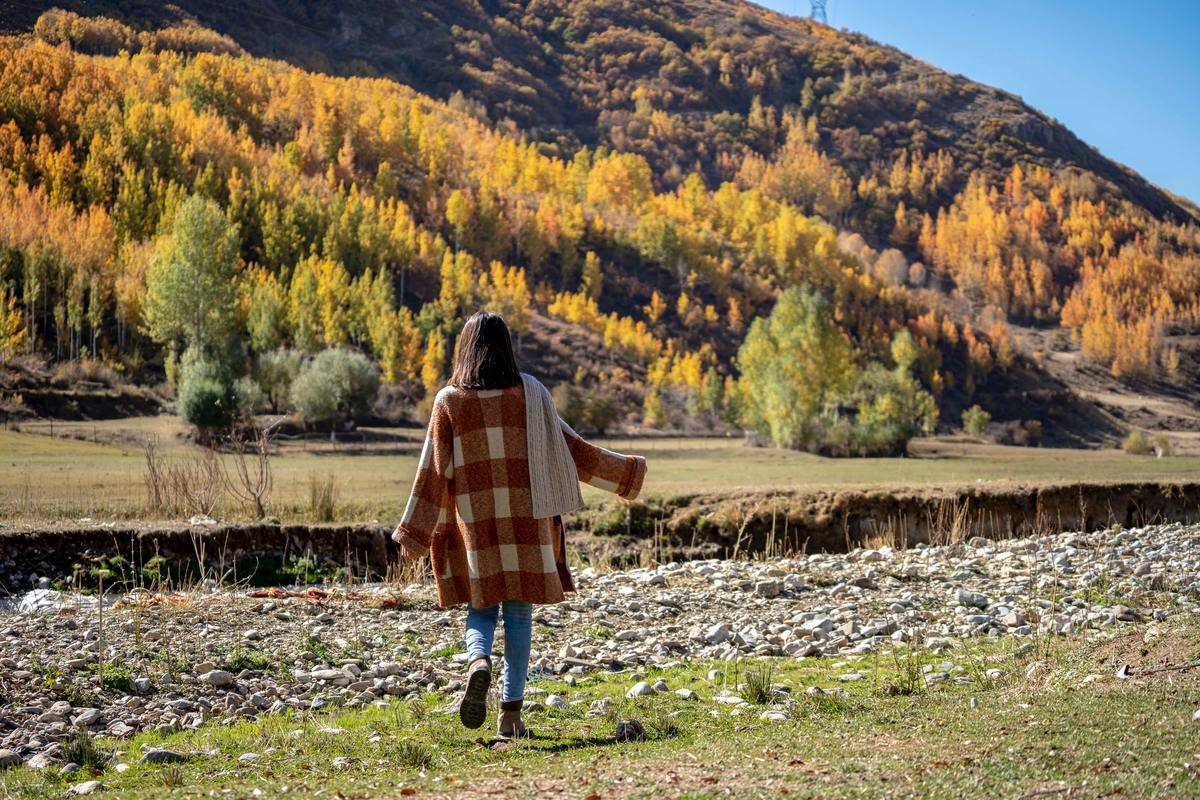 Woman walking alone into field 