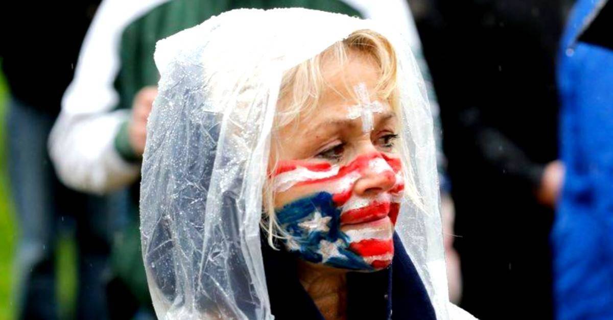 woman with american flag facepaint in the rain
