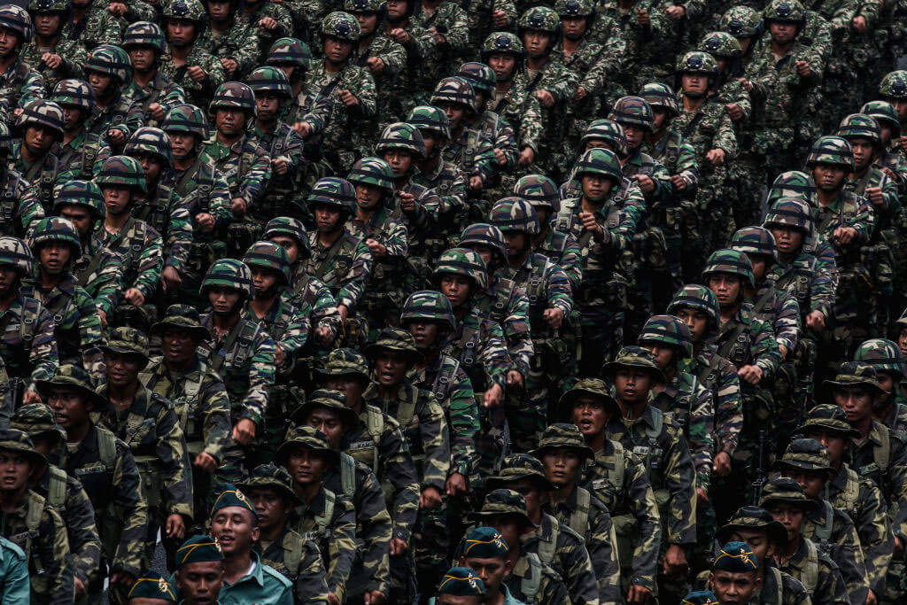 Malaysian army in rows lrunning marching drills