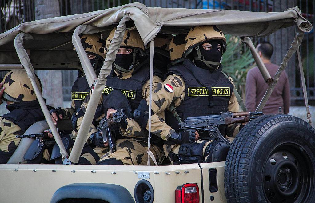 Egyptian military special forced ride in back of pickup truck