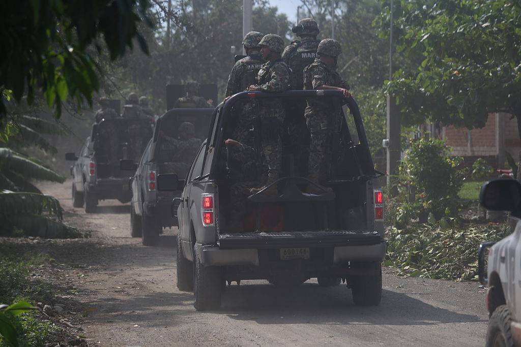 Mexican soldiers riding in convoy