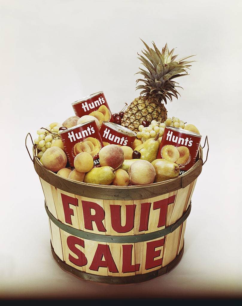 Fruits with tin cans in bucket