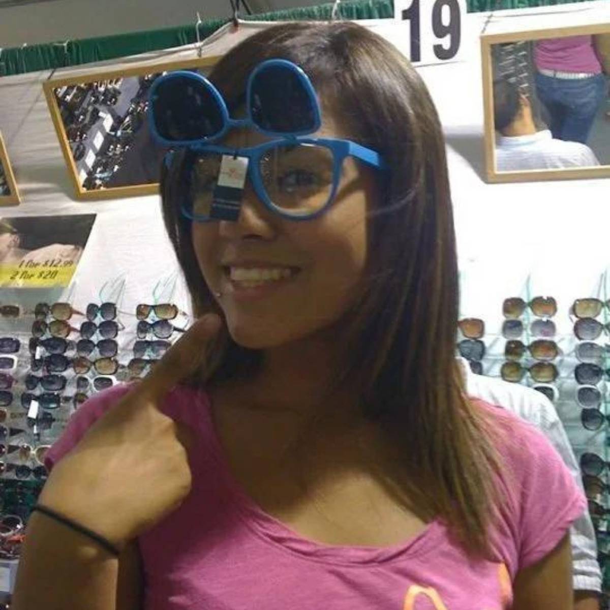 reflection of guy in the mirror checking out woman's behind