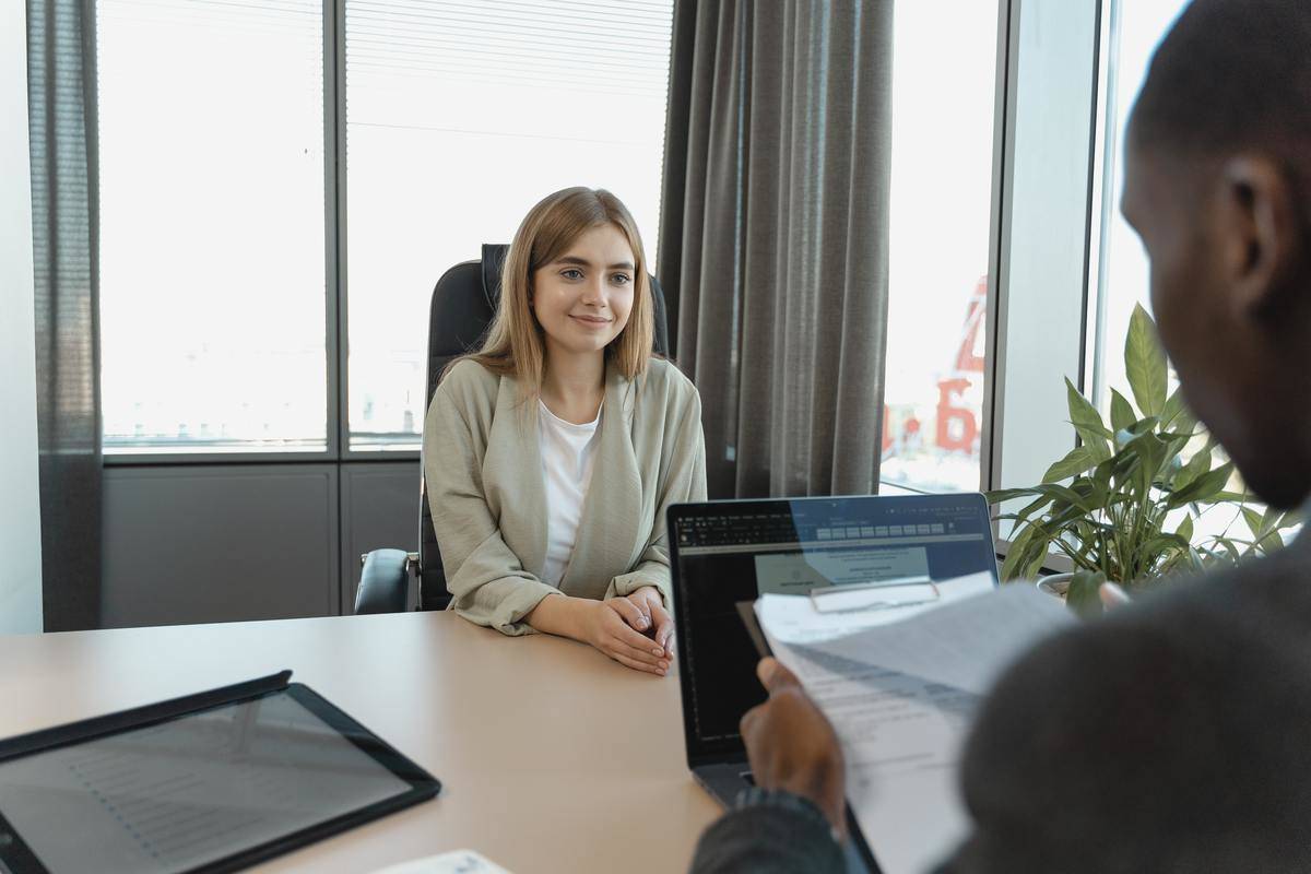 Woman sitting at interview across from man