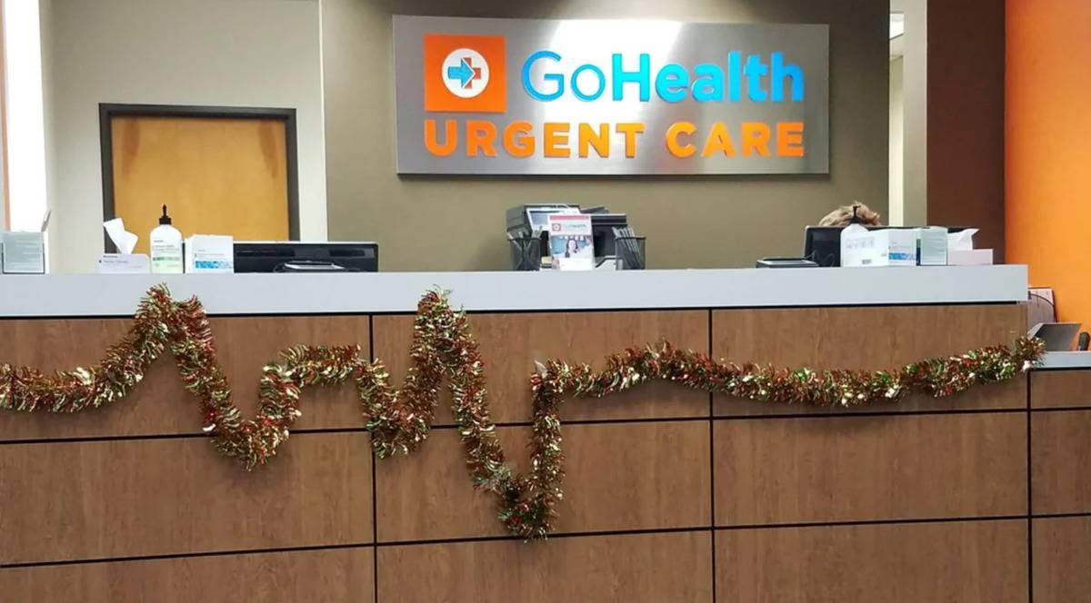 Reception desk at urgent care clinic with colorful Christmas wreath in the shape of heart monitor lines