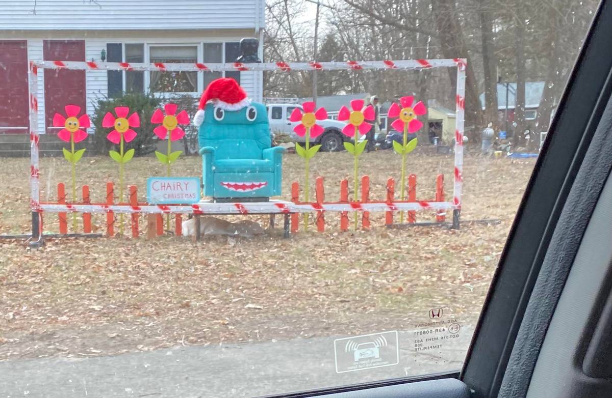 Christmas lawn display with happy flowers and Chairy from Pee Wee's Playhouse in Santa hat