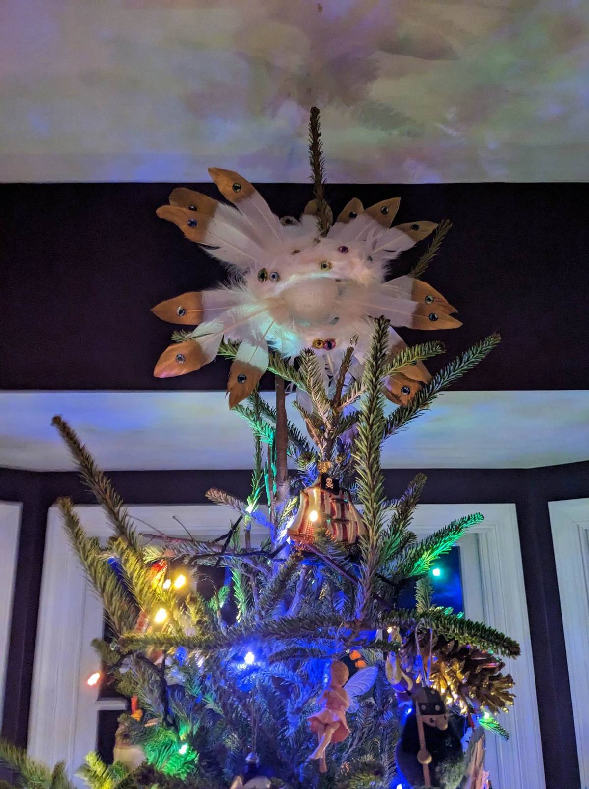 Christmas tree with homemade representation of a Biblically accurate angel on top