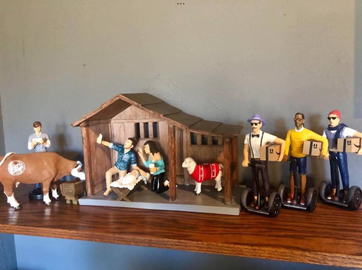 Nativity scene decorated with millennial figurines and hipster Magi on segways