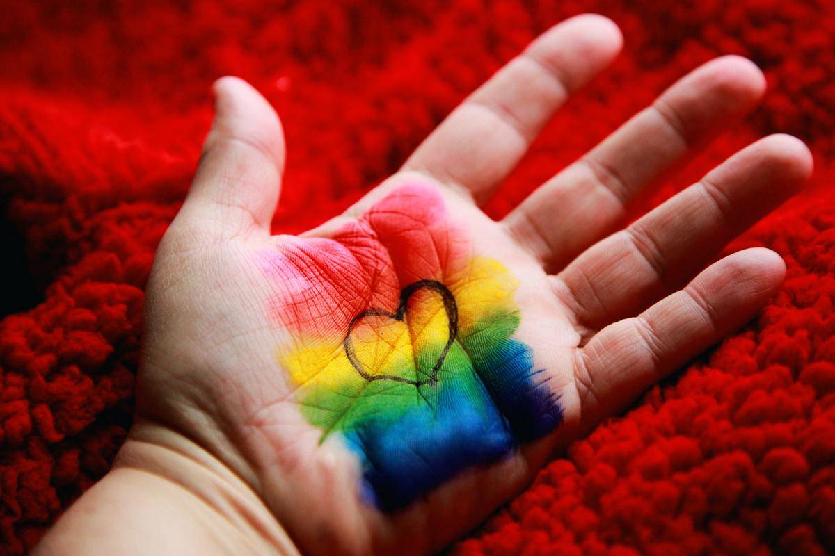 Hand painted with the colors of the rainbow and a heart shape drawn in black marker