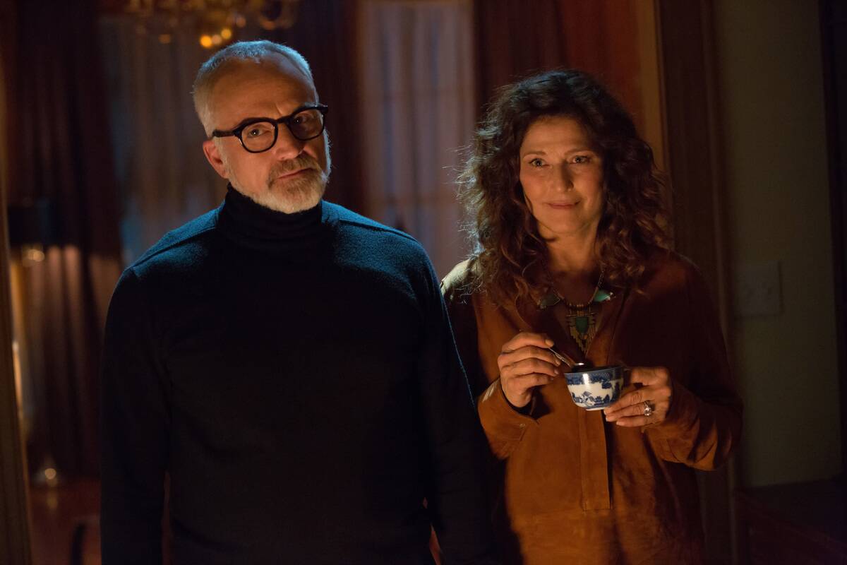 Bradley Whitford and Catherine Keener standing in sinister fashion as Dean and Missy Armitage in Get Out