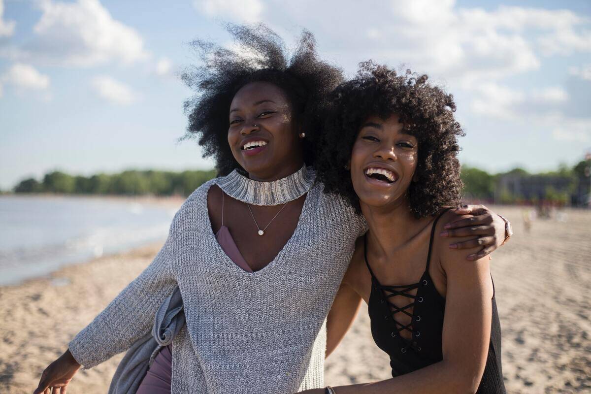 Sisters embracing happily on the beach