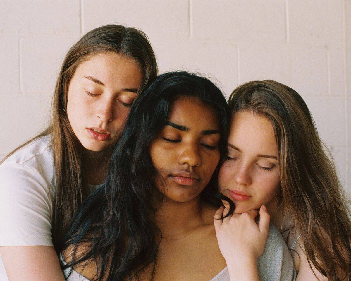 Woman embracing with their eyes closed