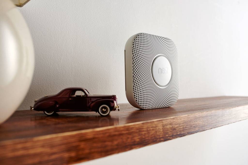 carbon monoxide detector on a shelf with a toy car