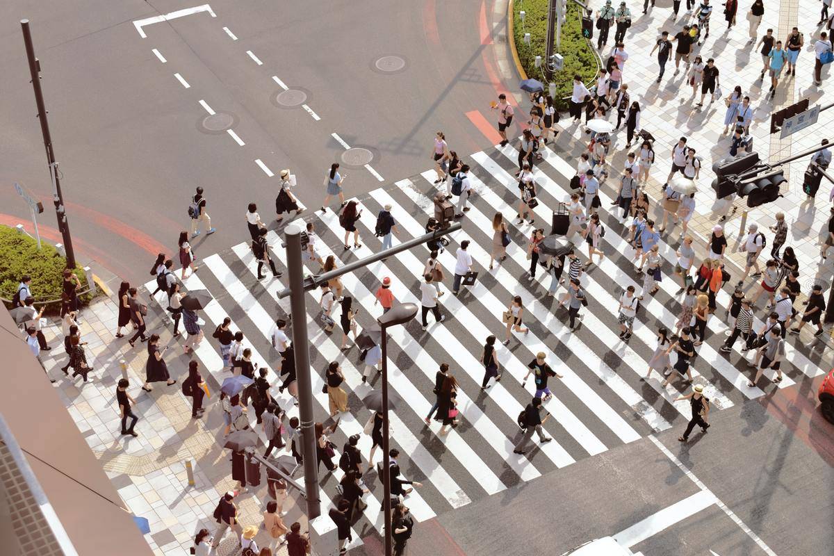 crowd walking across the street