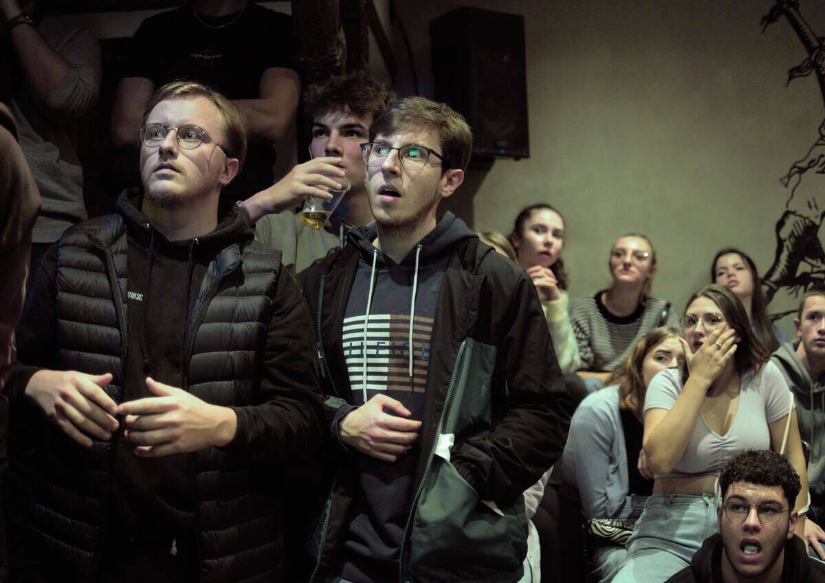 group reacting in shock to something off-camera