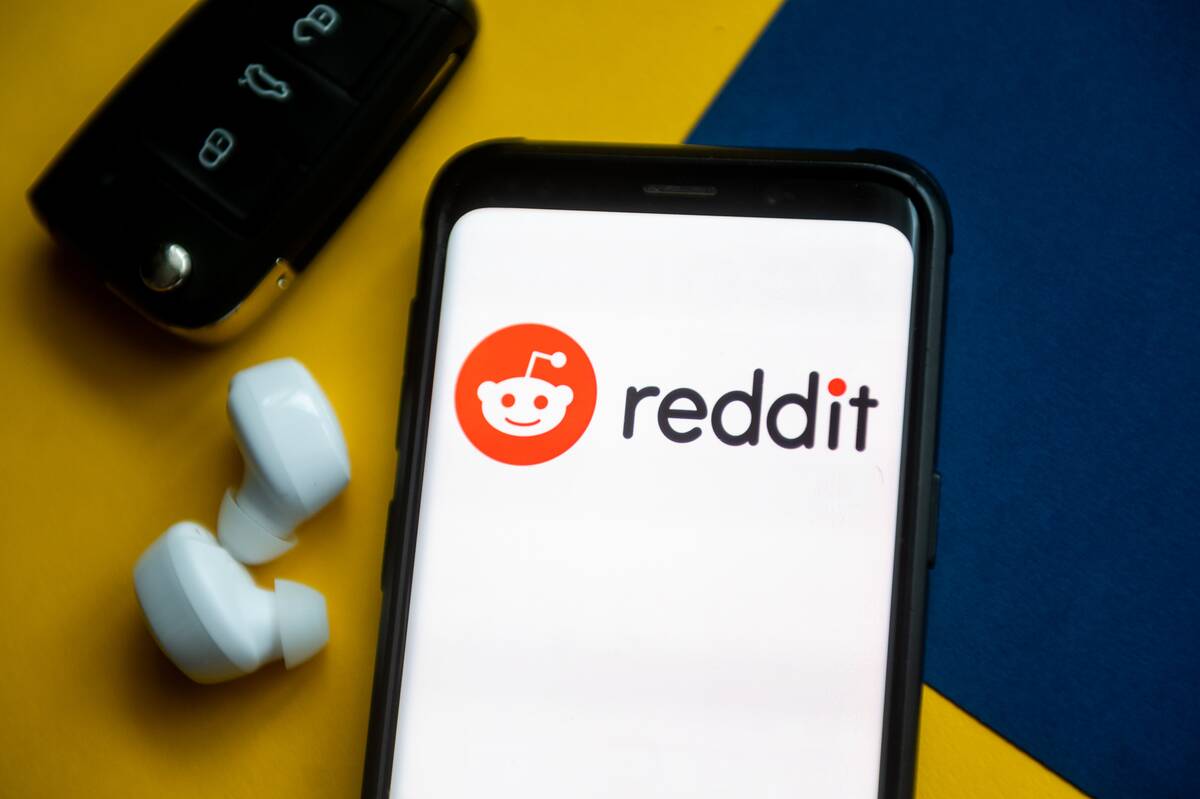 In this photo illustration a Reddit logo seen displayed on a...