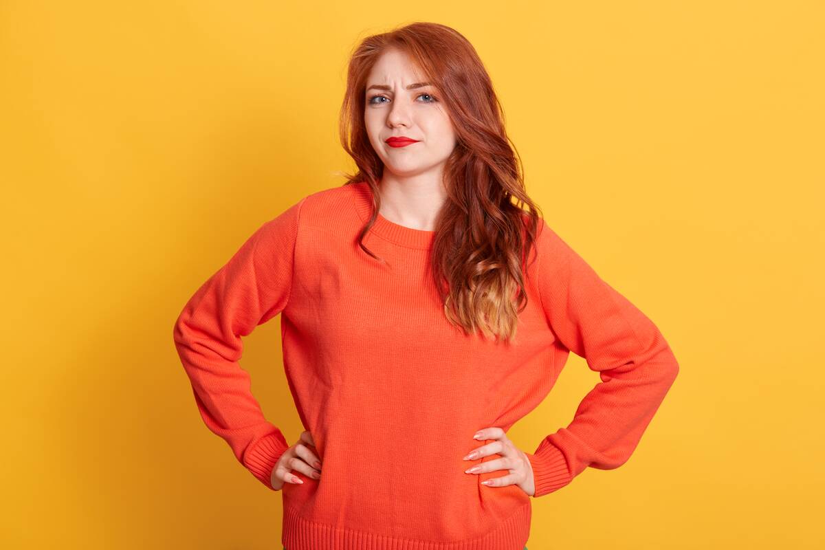 indignant woman standing with hands on hips