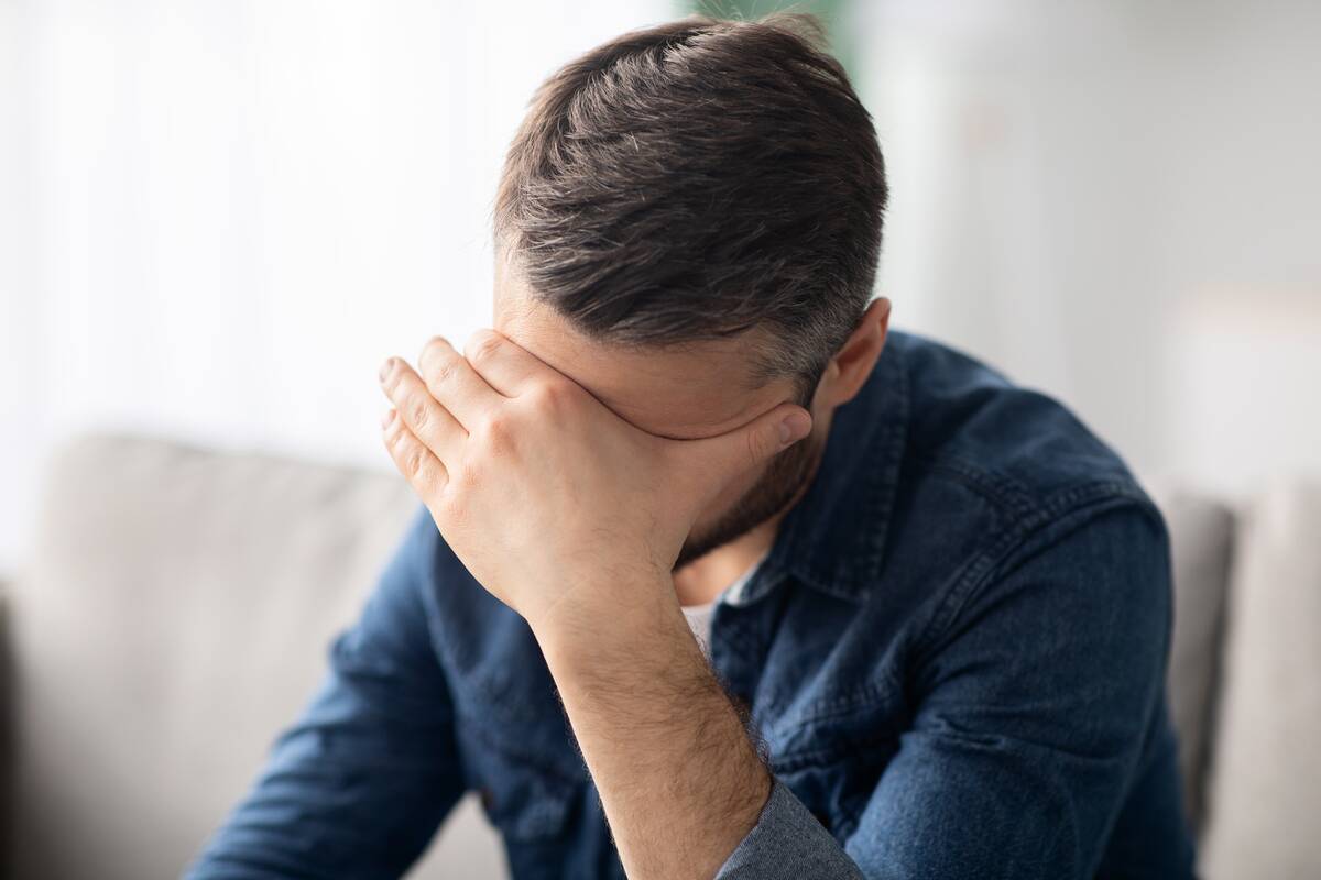 upset-man-having-headache-touching-his-forehead-2022-12-16-08-36-01-utc