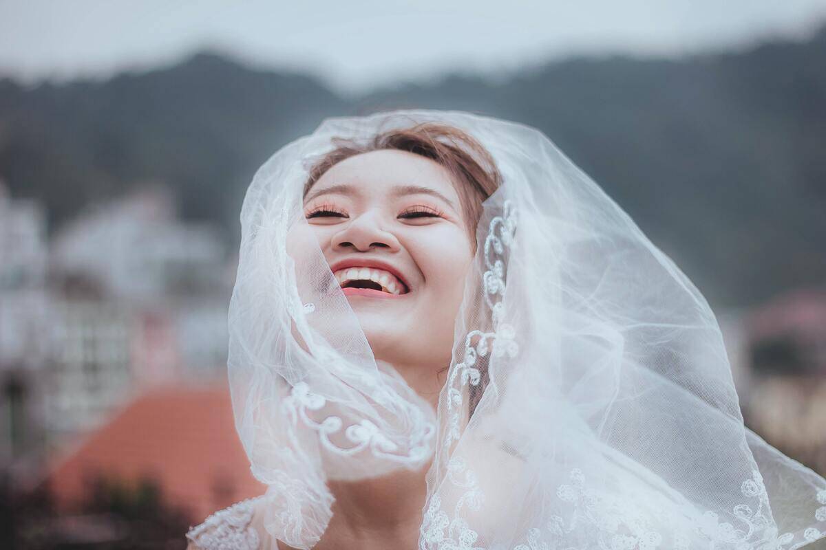 woman beaming in bridal gown