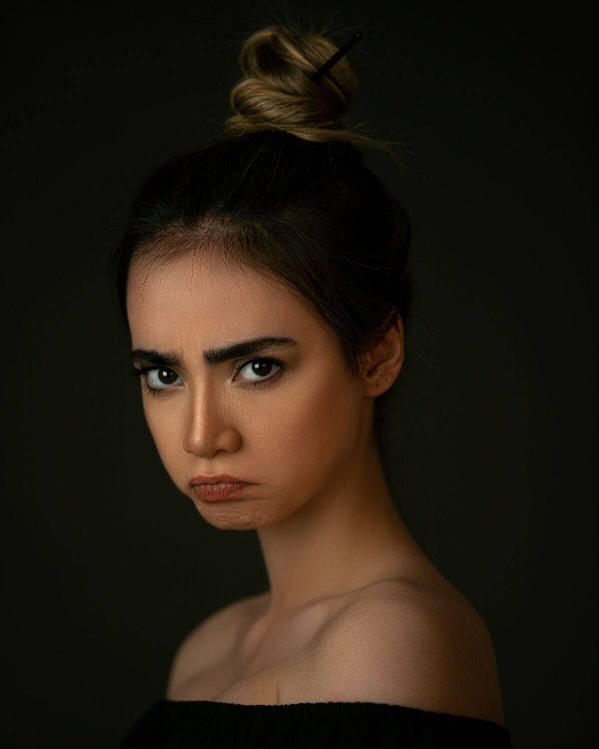 woman pouting as she stares sadly