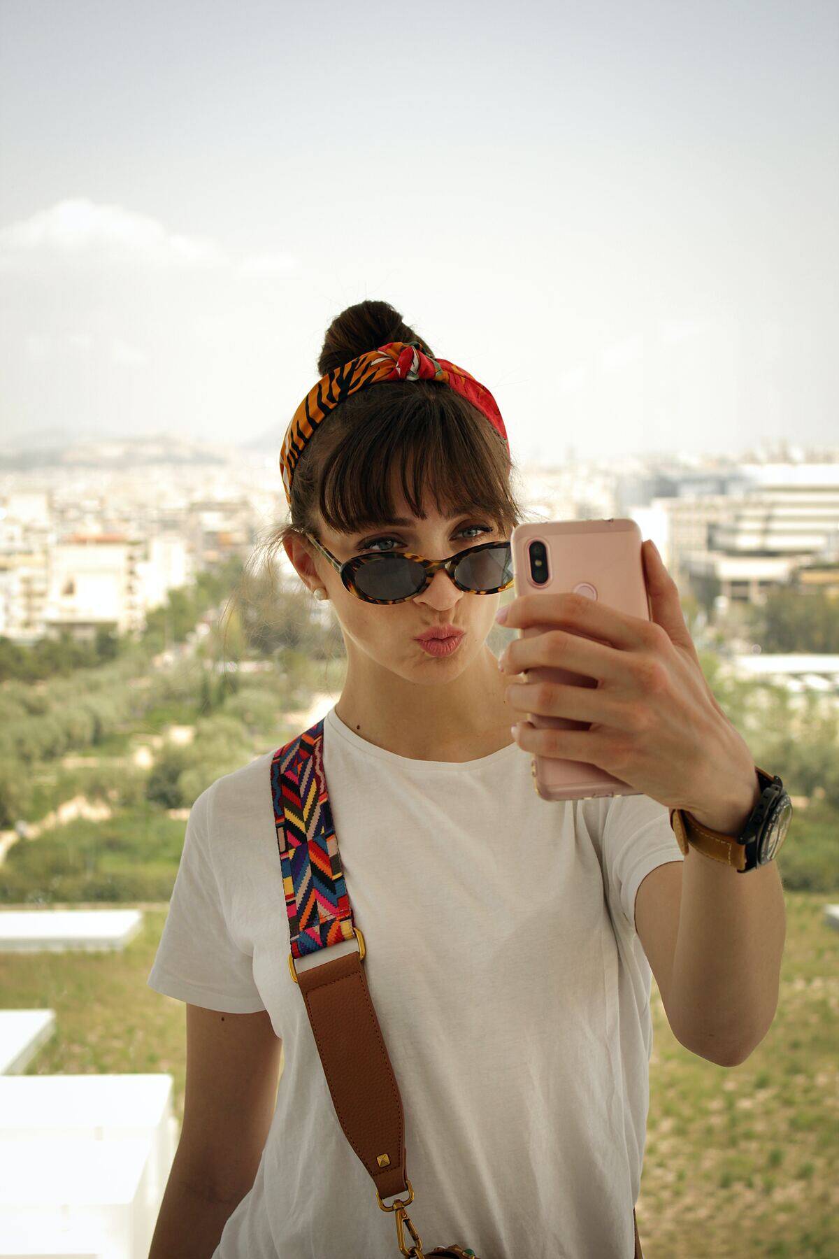 woman puckering lips as she takes selfie