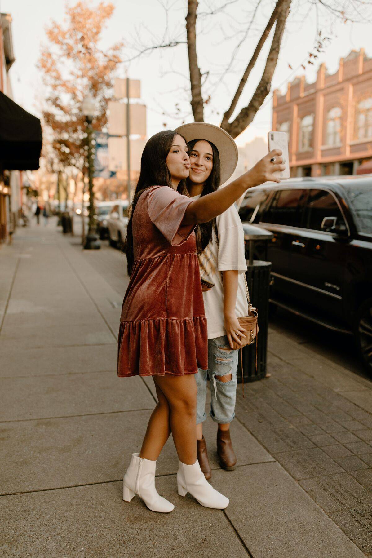 woman puckering lips while taking selfie with her sister