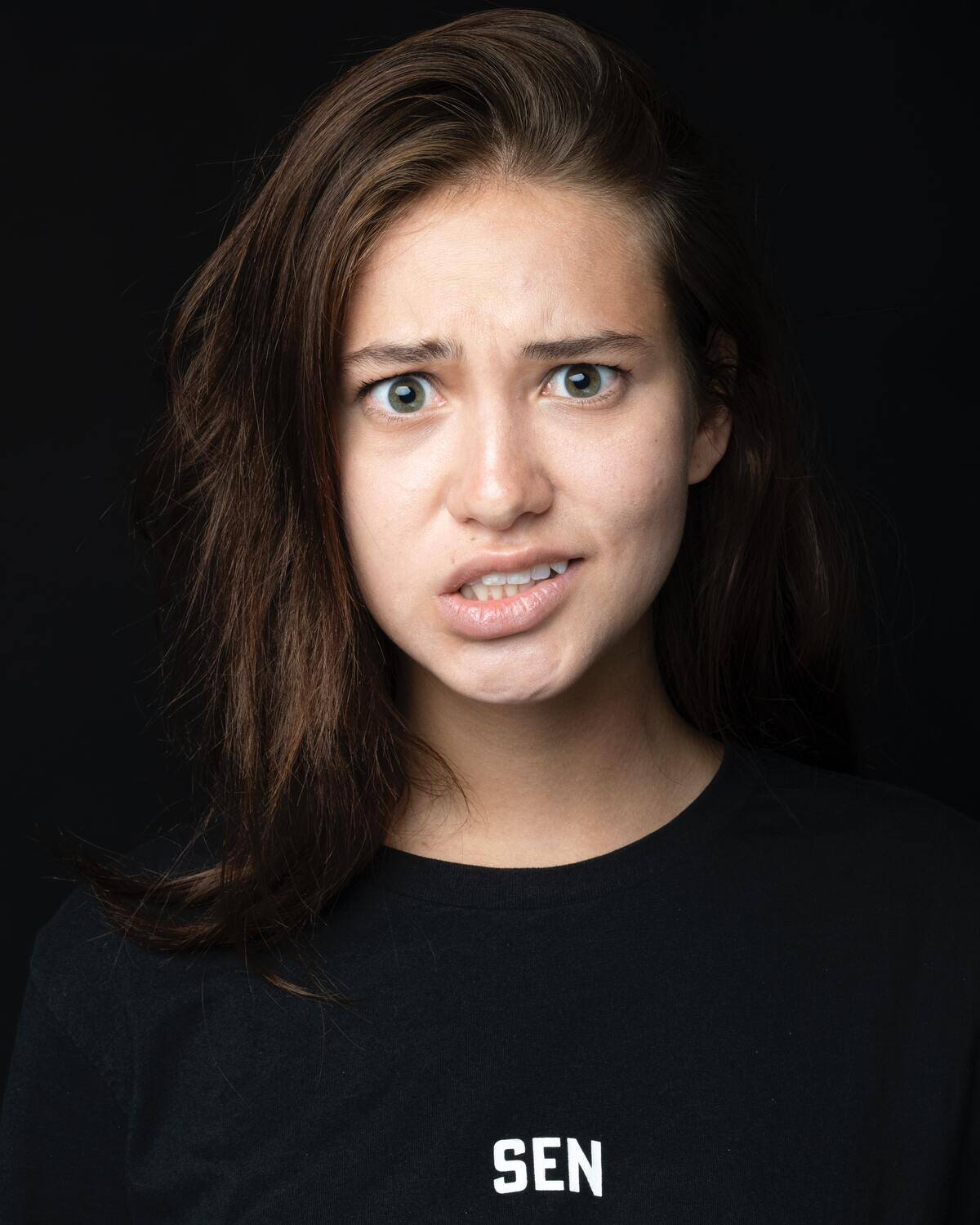 woman staring forward with confused facial expression