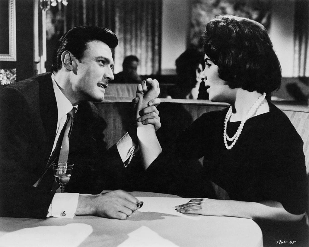 man grabbing Elizabeth Taylor's wrist in a movie