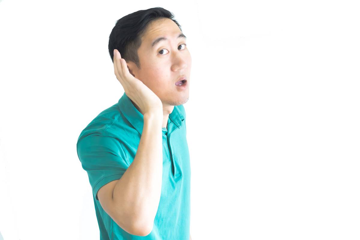 young-asian-man-trying-to-listen-to-something-2022-12-16-09-57-01-utc