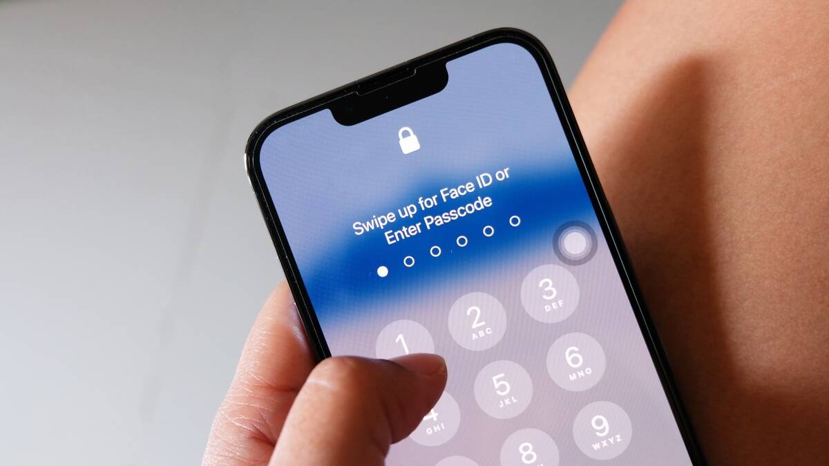 hand-holding-smartphone-black-entering-the-passcod-2022-11-08-08-38-50-utc