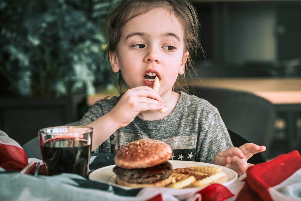 little-girl-in-cafe-with-burger-2021-09-01-02-39-57-utc