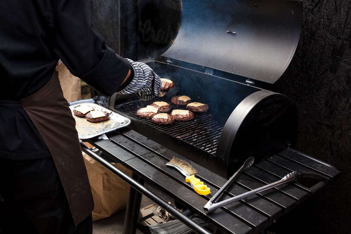 photo-of-man-cooking-burgers-on-big-grill-2021-12-09-17-32-39-utc