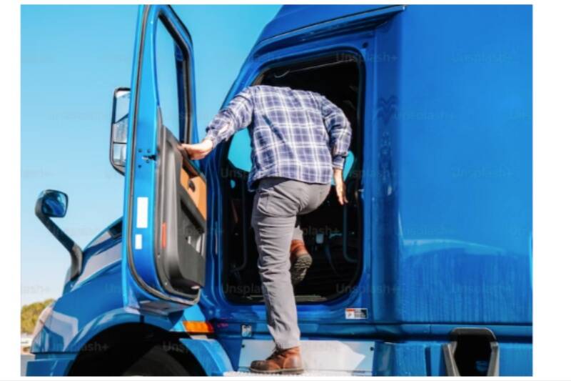 Truck Driver getting into cab