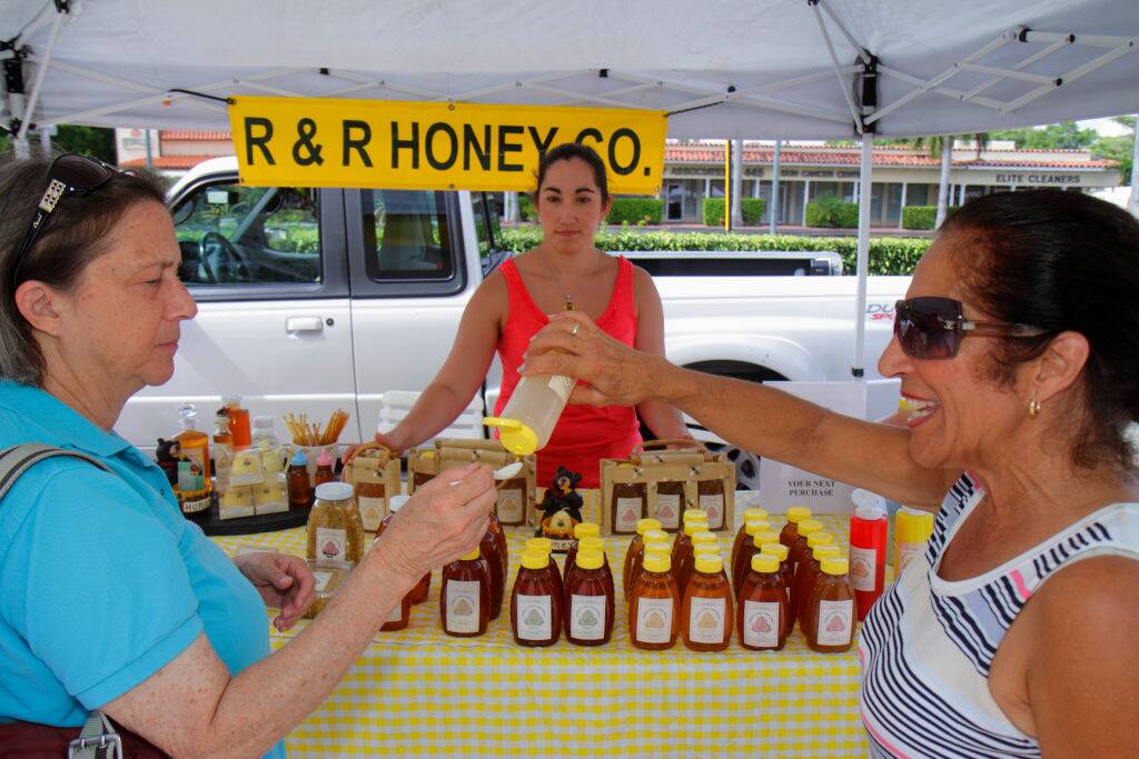 Women sampling honey