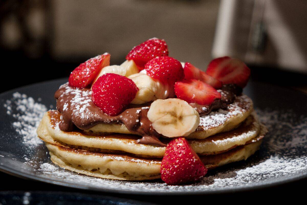strawberries and bananas on pancakes