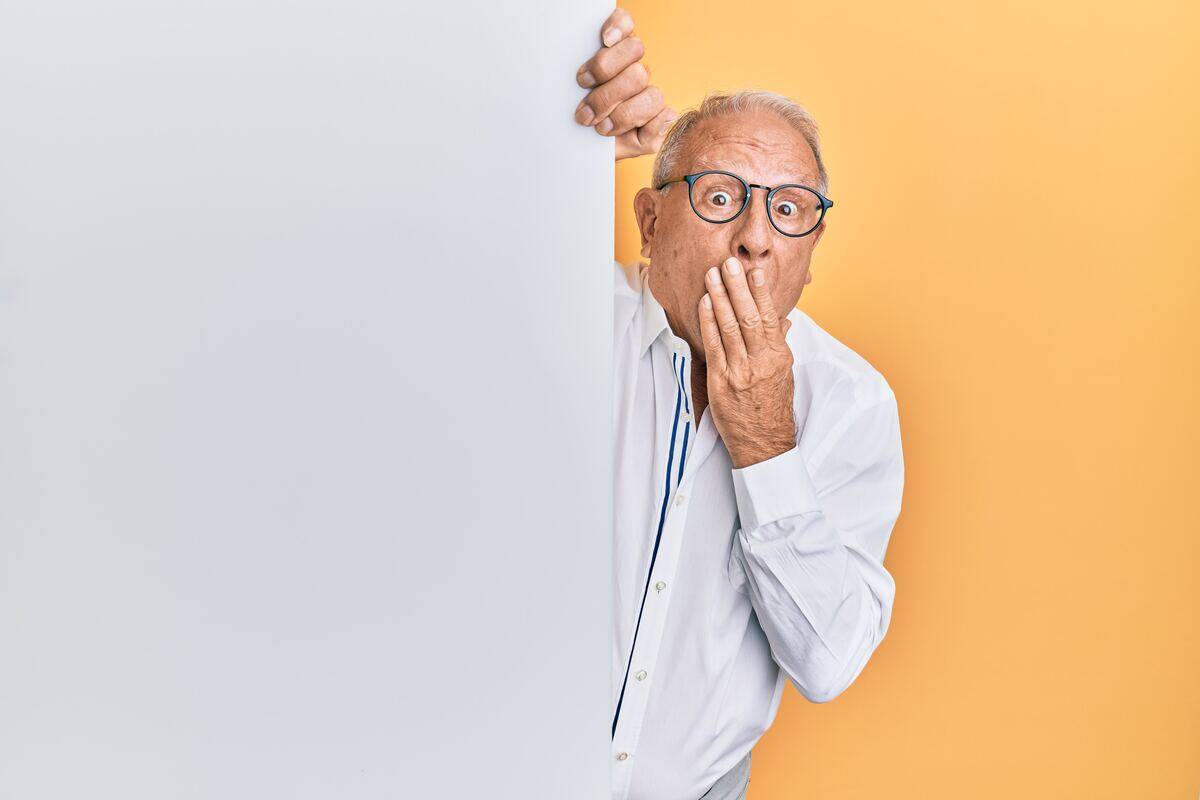 older man covering his mouth