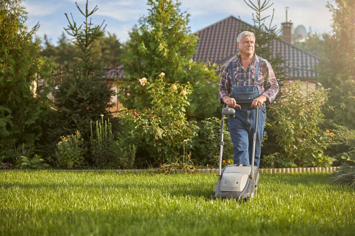 older man mowing the lawn